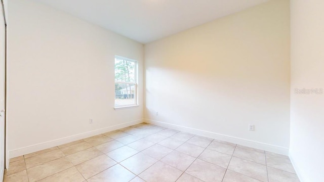 spare room with light tile patterned floors