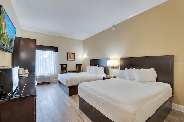 bedroom with crown molding and light wood-type flooring