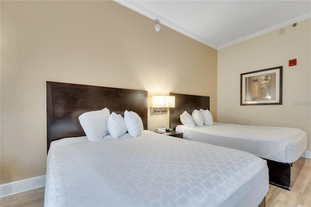 bedroom with crown molding and light wood-type flooring