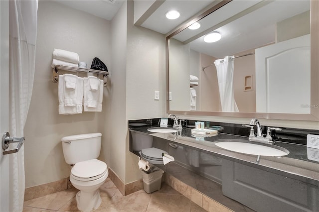 bathroom featuring vanity, toilet, walk in shower, and tile patterned flooring