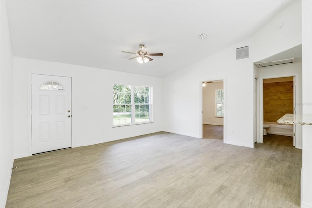 unfurnished living room featuring light hardwood / wood-style floors, lofted ceiling, and ceiling fan