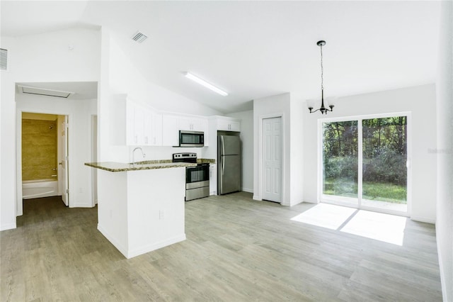 kitchen with stainless steel appliances, light stone countertops, vaulted ceiling, pendant lighting, and white cabinetry