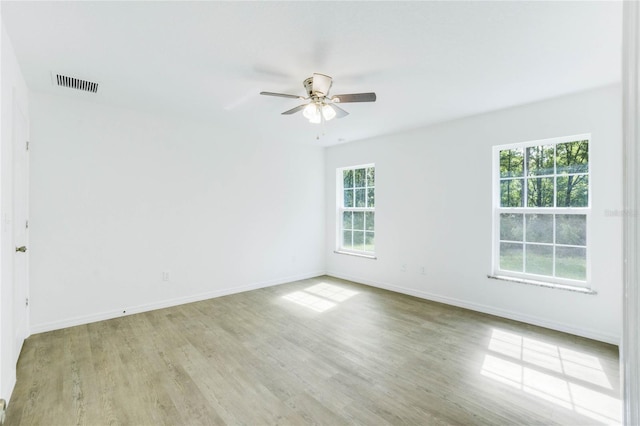 unfurnished room with light hardwood / wood-style floors, plenty of natural light, and ceiling fan