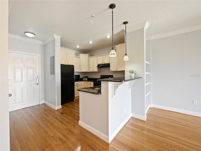 kitchen with a peninsula, dark countertops, a textured ceiling, black appliances, and under cabinet range hood