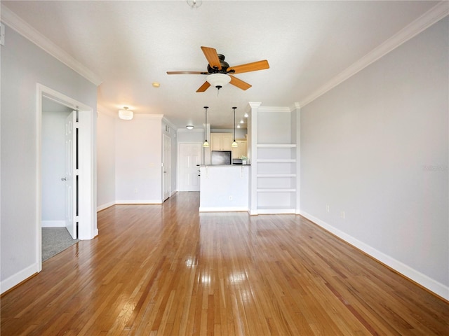 unfurnished living room featuring ceiling fan, wood-type flooring, and ornamental molding