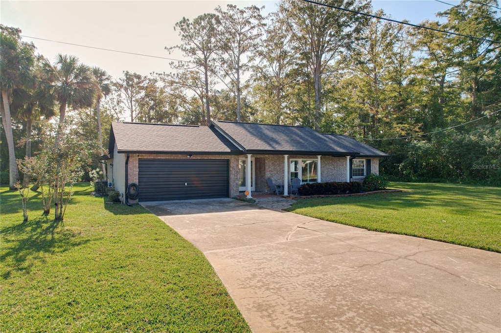 ranch-style house featuring a garage and a front yard