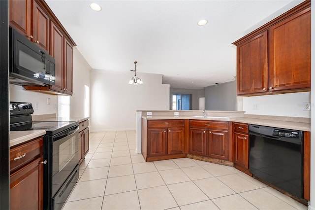 kitchen featuring a healthy amount of sunlight, black appliances, sink, and a chandelier