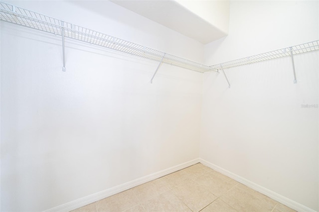 spacious closet with light tile patterned floors