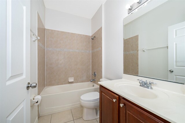 full bathroom featuring vanity, toilet, tile patterned floors, and tiled shower / bath