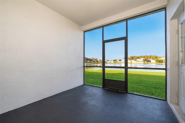 unfurnished sunroom with a water view