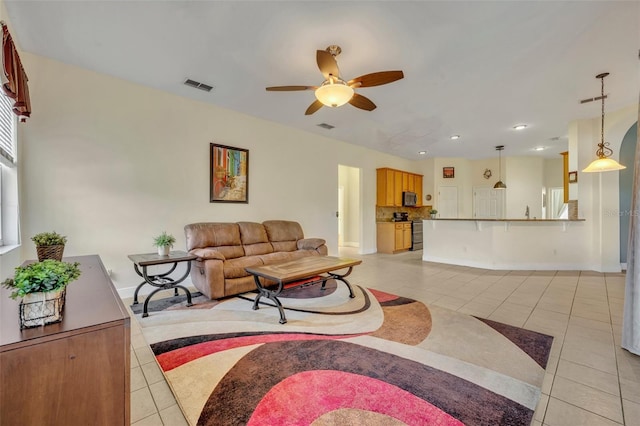 tiled living room featuring ceiling fan