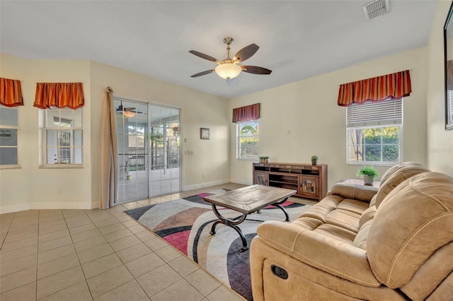 living room with ceiling fan and light tile patterned floors