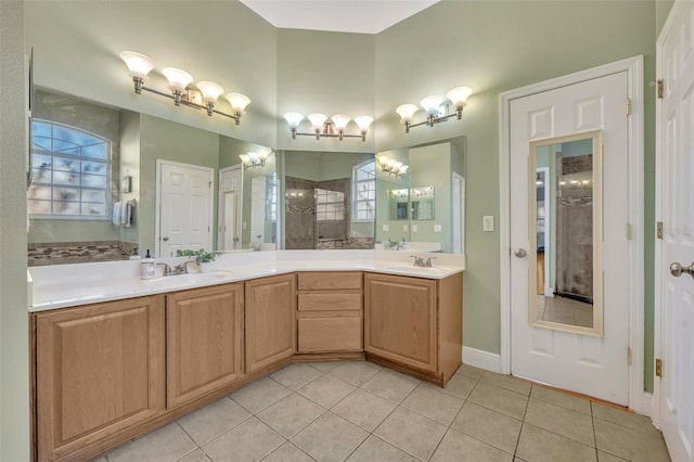 bathroom featuring vanity, tiled shower, and tile patterned flooring