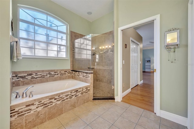 bathroom with shower with separate bathtub and tile patterned floors