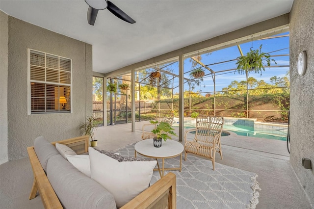 sunroom with a swimming pool and ceiling fan