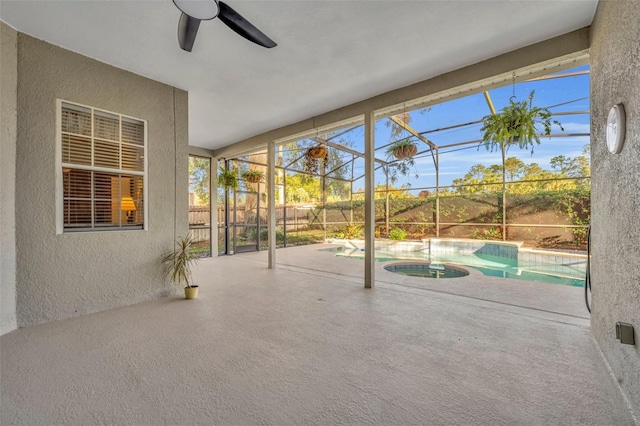 unfurnished sunroom with a swimming pool and ceiling fan