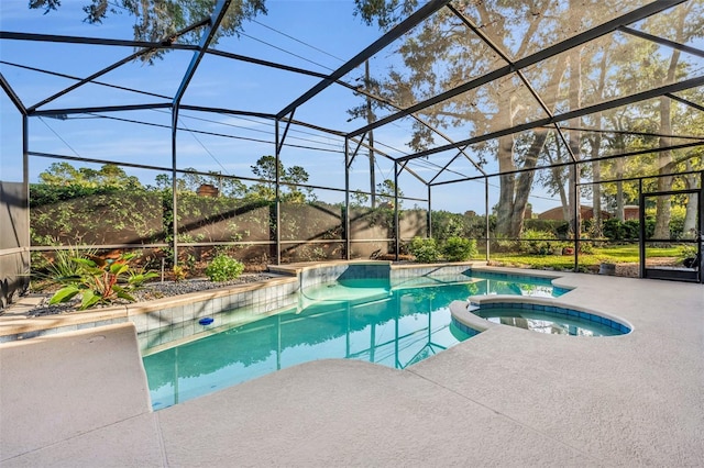 view of pool featuring a patio area, an in ground hot tub, and glass enclosure