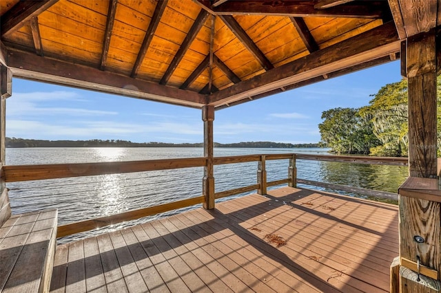 view of dock with a gazebo and a deck with water view