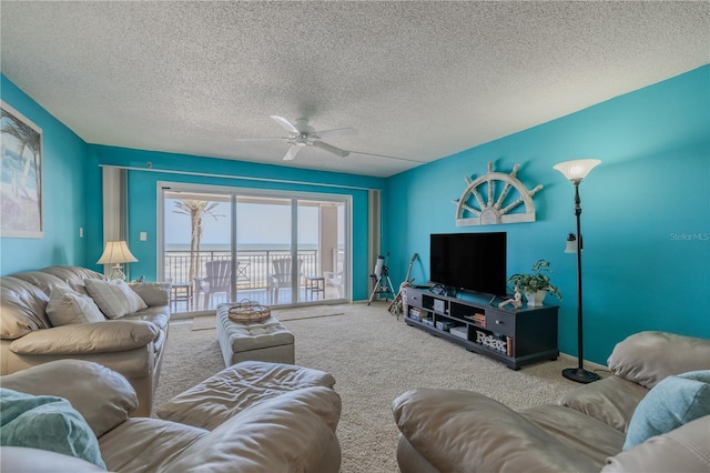 carpeted living room featuring a textured ceiling and ceiling fan