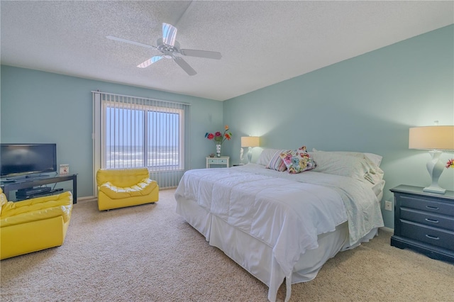 carpeted bedroom featuring a textured ceiling and ceiling fan