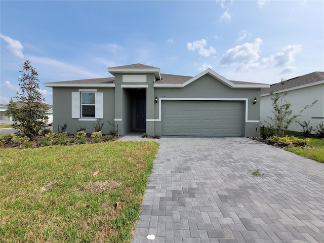 view of front of home with a front lawn and a garage