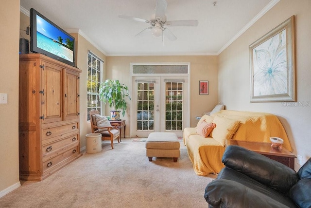 sitting room with french doors, light carpet, ornamental molding, and ceiling fan