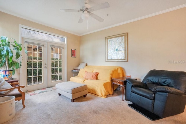 sitting room with french doors, ceiling fan, light colored carpet, and crown molding