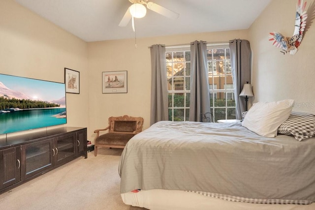 bedroom featuring light carpet and ceiling fan