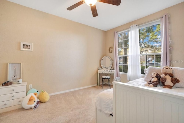 bedroom featuring light colored carpet and ceiling fan