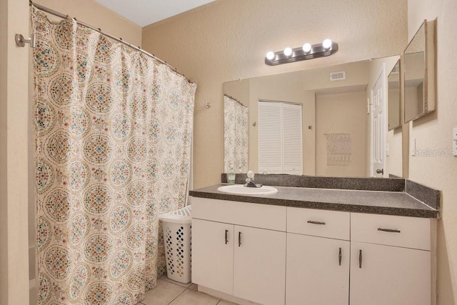 bathroom featuring vanity, a shower with curtain, and tile patterned floors