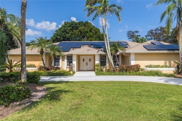 ranch-style house featuring solar panels and a front lawn