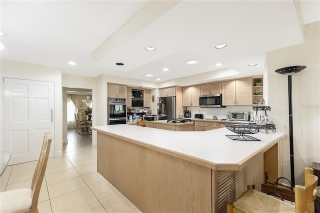 kitchen featuring kitchen peninsula, light tile patterned floors, a tray ceiling, light brown cabinetry, and stainless steel appliances