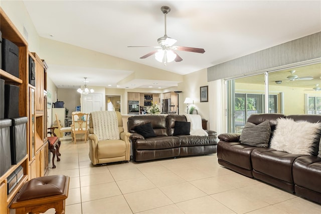 living room with vaulted ceiling, ceiling fan with notable chandelier, and light tile patterned floors