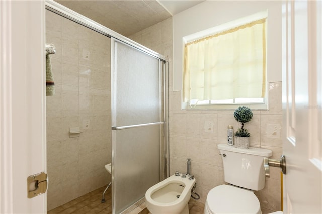 bathroom featuring toilet, a bidet, tile walls, and a shower with door