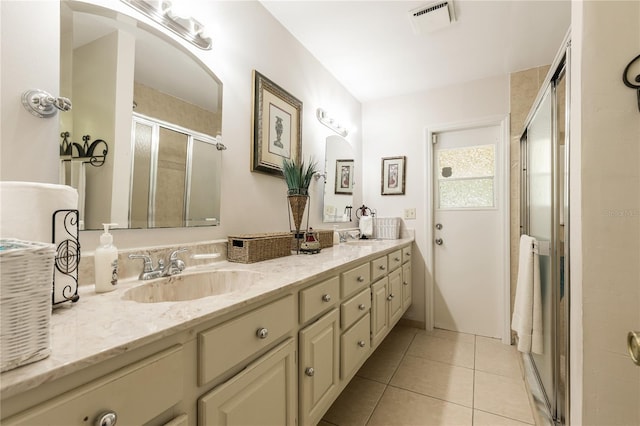 bathroom featuring vanity, tile patterned floors, and an enclosed shower