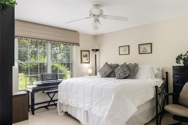 tiled bedroom featuring ceiling fan