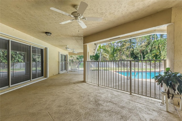 view of patio with ceiling fan and a fenced in pool