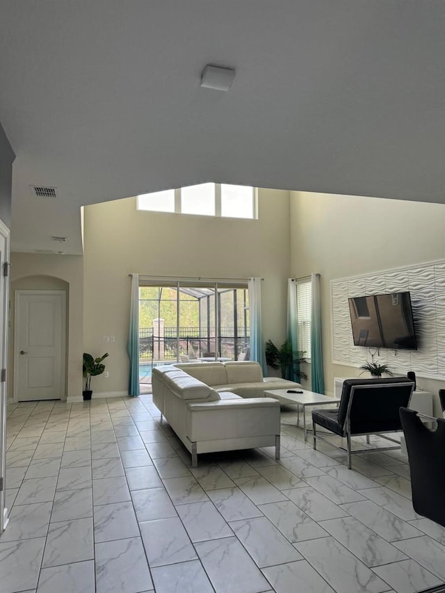 living room featuring a towering ceiling