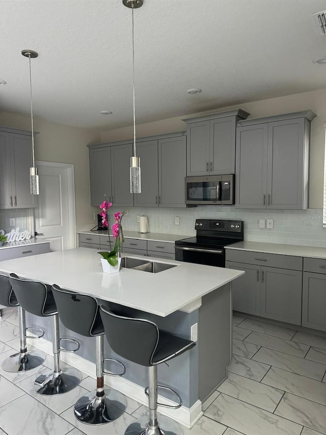 kitchen with gray cabinets and black range with electric stovetop