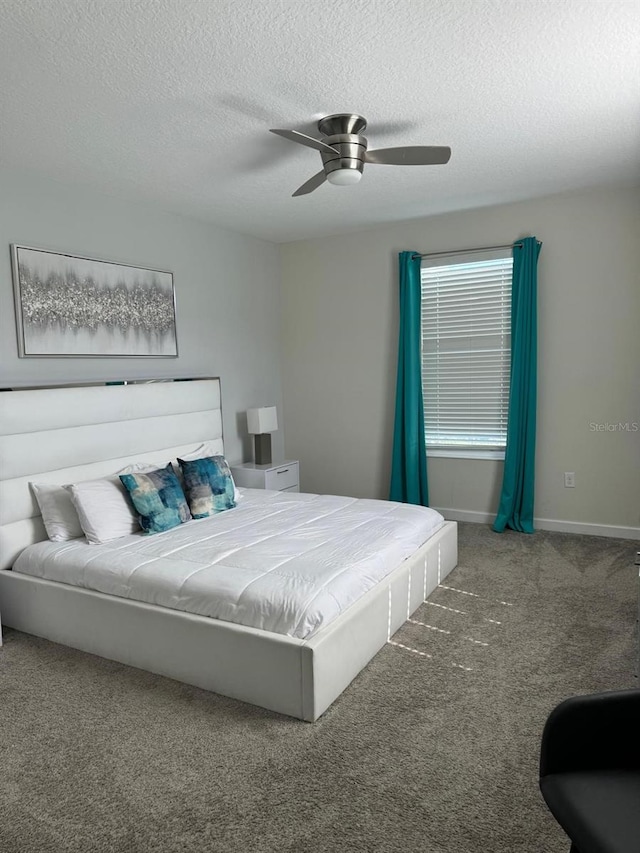 carpeted bedroom featuring a textured ceiling and ceiling fan