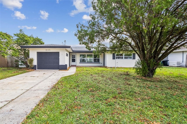 ranch-style house with a front yard and a garage