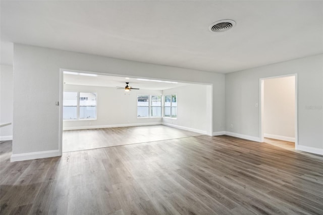 unfurnished living room with ceiling fan and hardwood / wood-style flooring