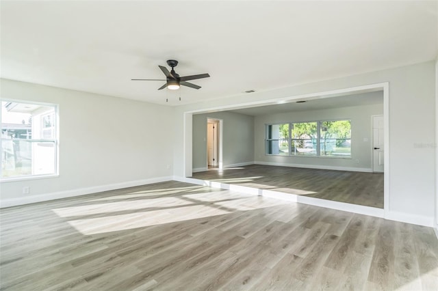 unfurnished room with hardwood / wood-style floors and ceiling fan