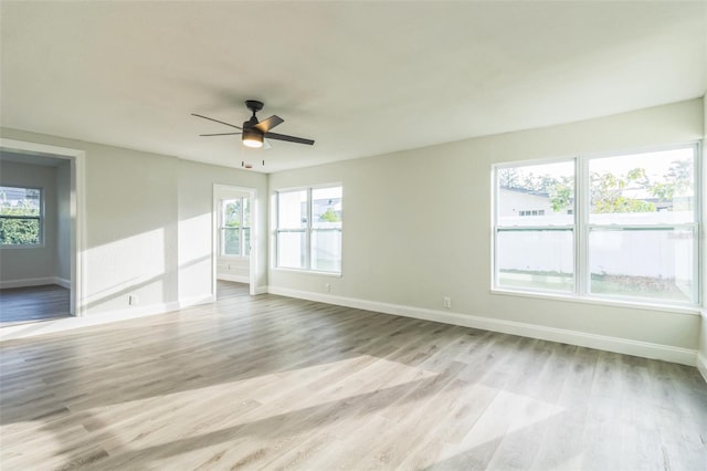 empty room with light hardwood / wood-style flooring and ceiling fan