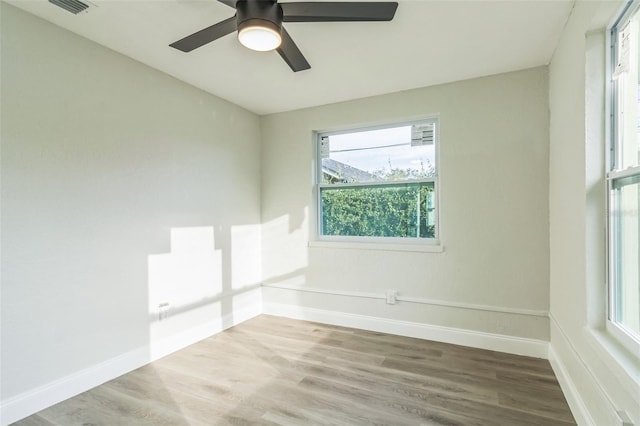 empty room with hardwood / wood-style flooring and ceiling fan