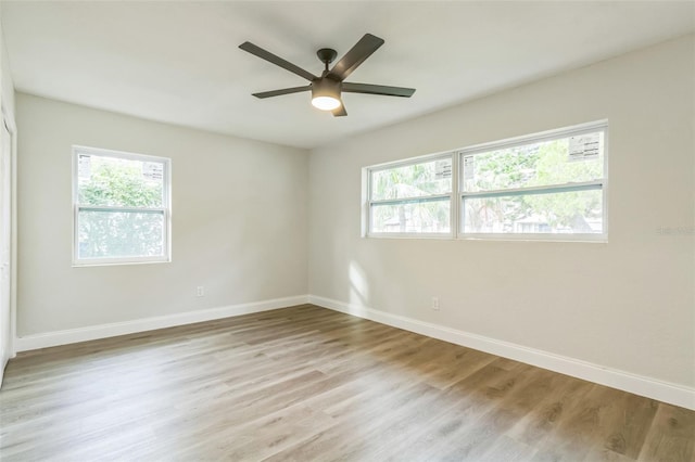 unfurnished room featuring light wood-type flooring and ceiling fan