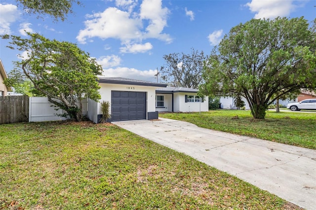 ranch-style home with a front lawn and a garage