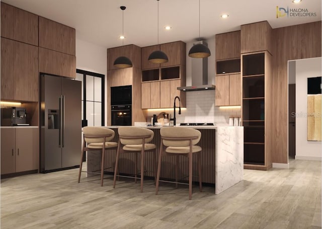 kitchen with decorative backsplash, light hardwood / wood-style flooring, pendant lighting, and stainless steel fridge