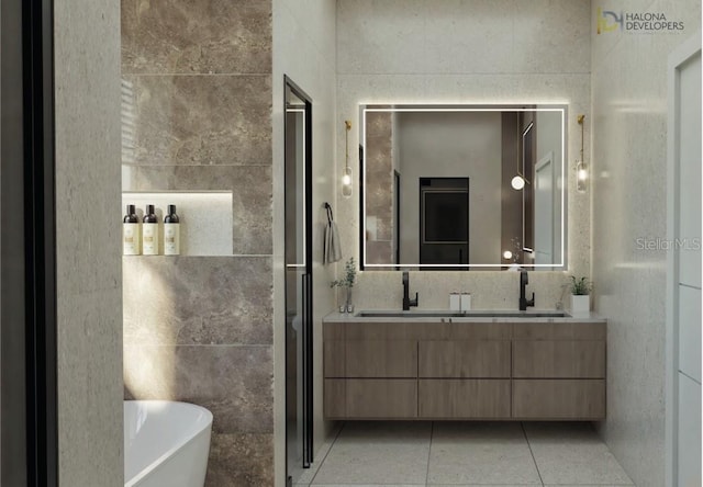 bathroom featuring vanity, a tub to relax in, tile patterned floors, and tile walls