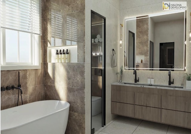 bathroom with vanity, toilet, tile patterned flooring, and a washtub